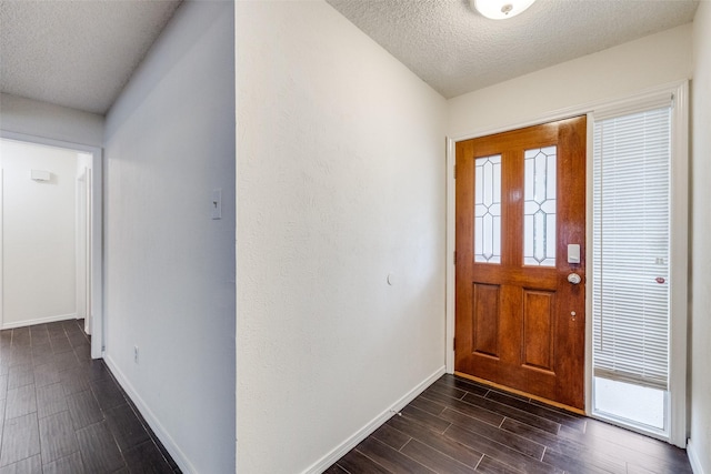 2505 Blue Quail Dr, Arlington, TX 76017 - foyer featuring a textured ceiling, baseboards, and dark wood-type flooring