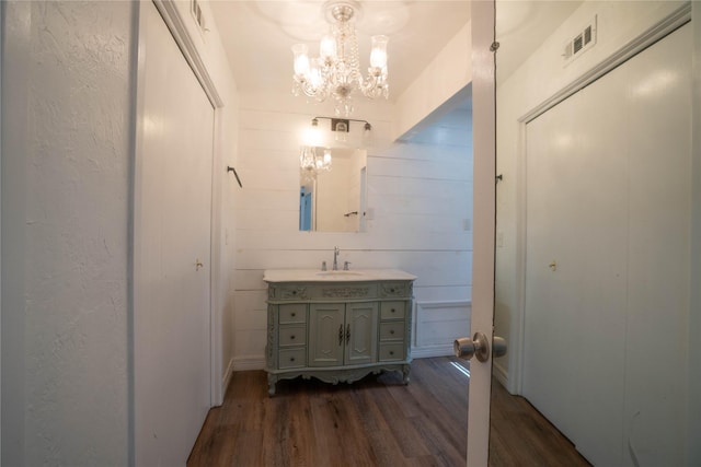 2206 Culbertson, Paris, TX 75460 - bathroom featuring wood finished floors, vanity, and a chandelier