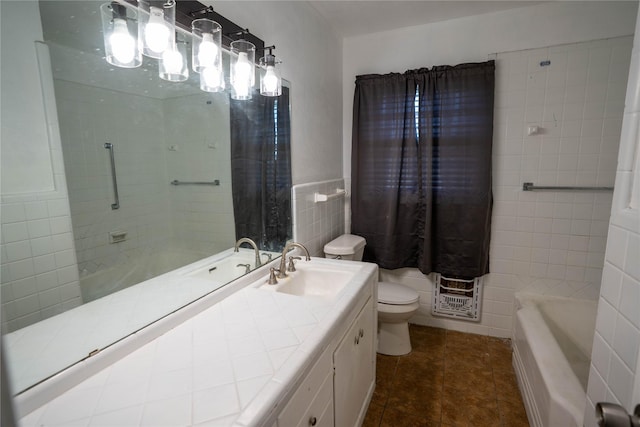 2206 Culbertson, Paris, TX 75460 - bathroom featuring toilet, vanity, tile walls, and tile patterned flooring
