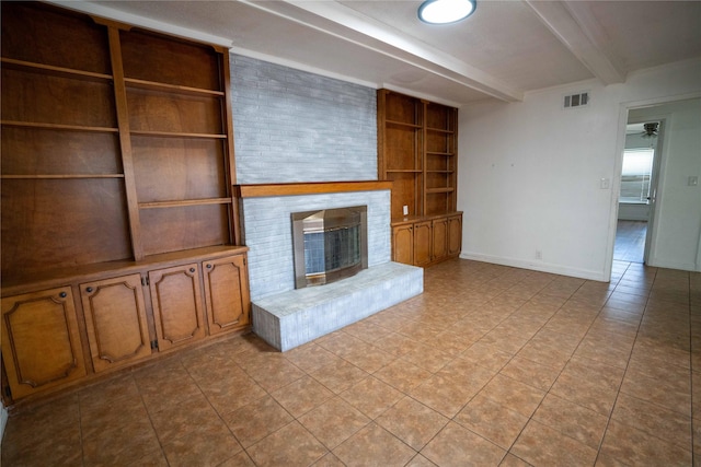 2206 Culbertson, Paris, TX 75460 - unfurnished living room featuring beamed ceiling, a brick fireplace, light tile patterned floors, built in features, and ceiling fan