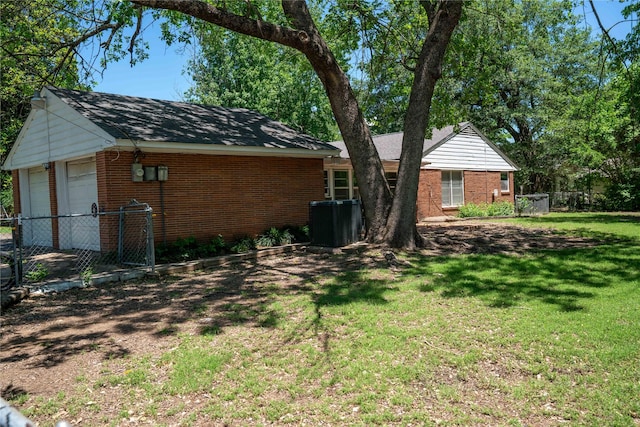 2206 Culbertson, Paris, TX 75460 - view of side of property featuring brick siding, central air condition unit, a detached garage, and an outdoor structure