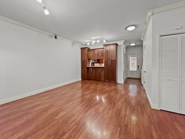 2727 Shelby Ave Unit X, Dallas, TX 75219 - unfurnished living room with crown molding, light wood-type flooring, and baseboards