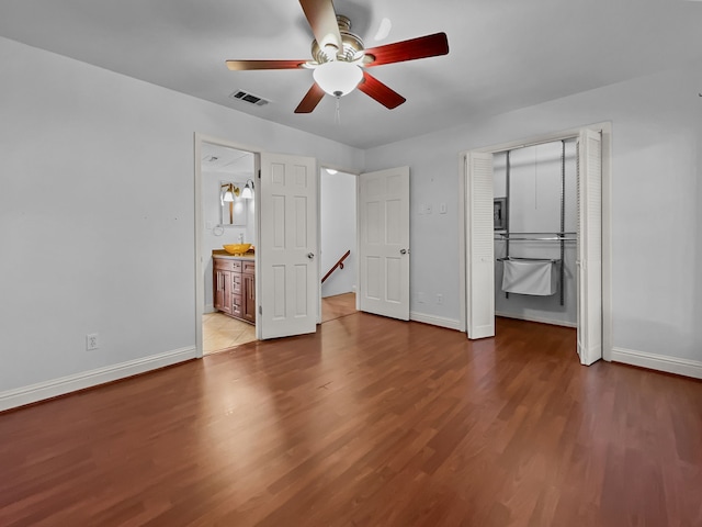 2727 Shelby Ave Unit X, Dallas, TX 75219 - unfurnished bedroom featuring wood finished floors, baseboards, and a ceiling fan