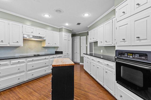 3410 Timbermill Rd, Waco, TX 76710 - kitchen with black appliances, crown molding, under cabinet range hood, butcher block counters, and recessed lighting