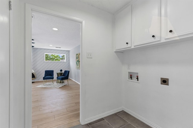 2100 Scarlet Oak Dr, Richardson, TX 75081 - laundry room featuring electric dryer hookup, cabinet space, baseboards, washer hookup, and a textured ceiling