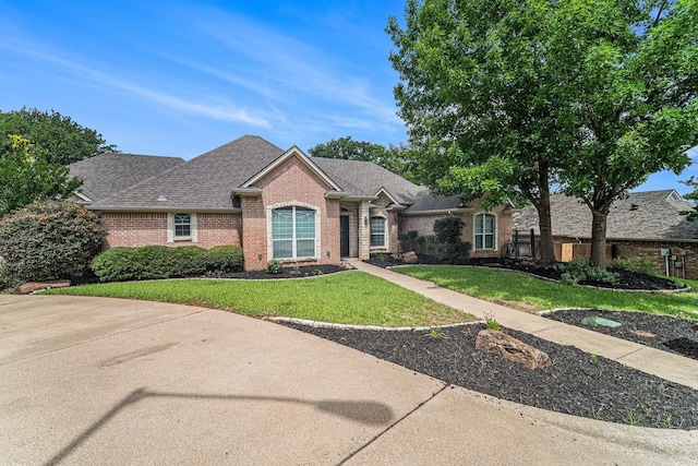 2005 Timber Cove Ct, Weatherford, TX 76087 - view of front of house featuring brick siding, a front lawn, and roof with shingles