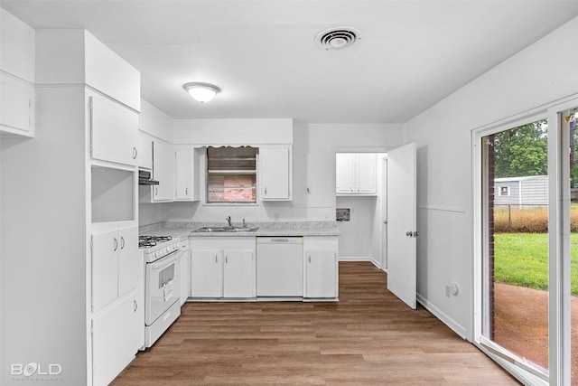 2541 Mecom Dr, Shreveport, LA 71104 - kitchen featuring white appliances, light countertops, light wood finished floors, a sink, and white cabinetry