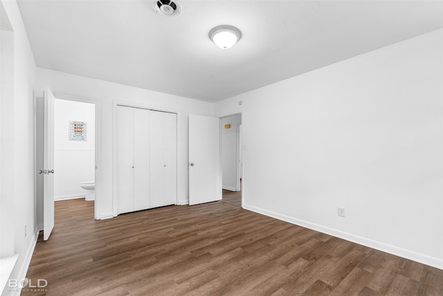 2541 Mecom Dr, Shreveport, LA 71104 - unfurnished bedroom with wood finished floors, baseboards, and a closet