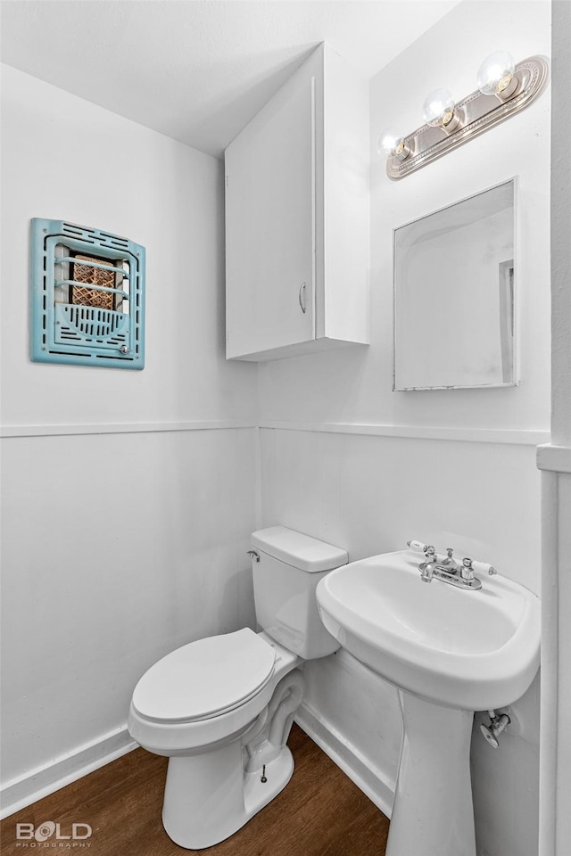 2541 Mecom Dr, Shreveport, LA 71104 - half bathroom featuring toilet, wood finished floors, and baseboards