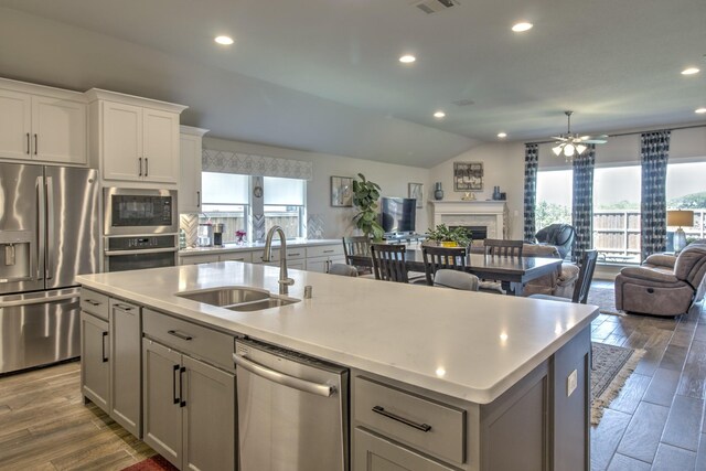 3609 Honey Suckle Ln, Little Elm, TX 75068 - kitchen featuring stainless steel appliances, a sink, open floor plan, an island with sink, and light countertops