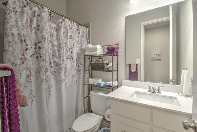 3609 Honey Suckle Ln, Little Elm, TX 75068 - bathroom featuring toilet, vanity, curtained shower, and a textured wall