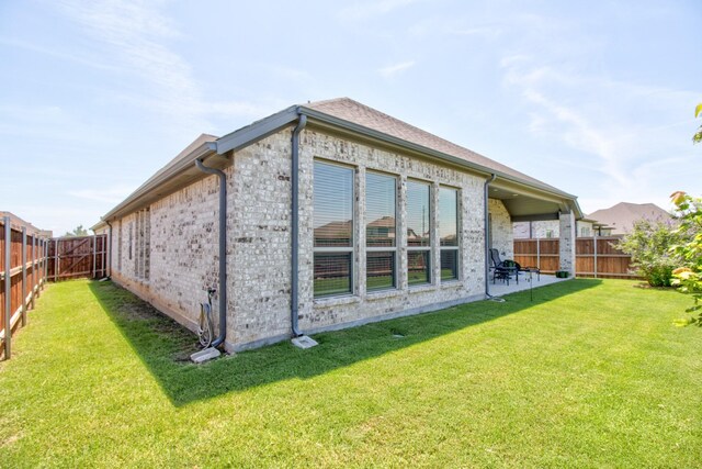 3609 Honey Suckle Ln, Little Elm, TX 75068 - rear view of property featuring brick siding and a patio
