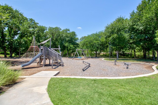 3609 Honey Suckle Ln, Little Elm, TX 75068 - communal playground featuring a yard and view of scattered trees