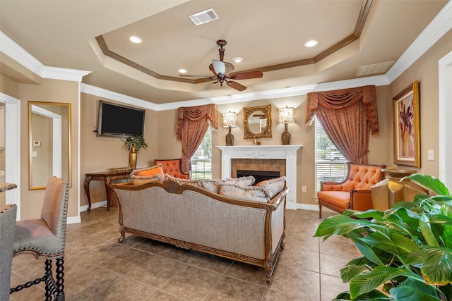 1300 Enchanted Rock Cir, Waco, TX 76712 - living area with ceiling fan, crown molding, a tray ceiling, light tile patterned floors, and recessed lighting