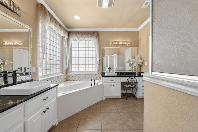 1300 Enchanted Rock Cir, Waco, TX 76712 - bathroom featuring two vanities, a bath, a stall shower, tile patterned floors, and crown molding