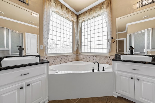 1300 Enchanted Rock Cir, Waco, TX 76712 - bathroom featuring healthy amount of natural light, two vanities, ornamental molding, a shower stall, and tile patterned flooring