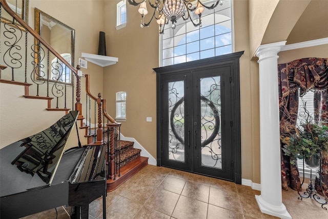 1300 Enchanted Rock Cir, Waco, TX 76712 - tiled entryway with french doors, decorative columns, a towering ceiling, and stairs
