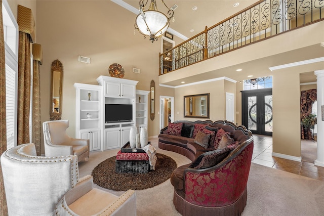 1300 Enchanted Rock Cir, Waco, TX 76712 - living area featuring a high ceiling, crown molding, a chandelier, tile patterned floors, and baseboards