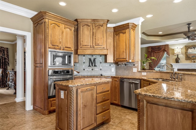 1300 Enchanted Rock Cir, Waco, TX 76712 - kitchen featuring stainless steel appliances, crown molding, a sink, light stone countertops, and recessed lighting
