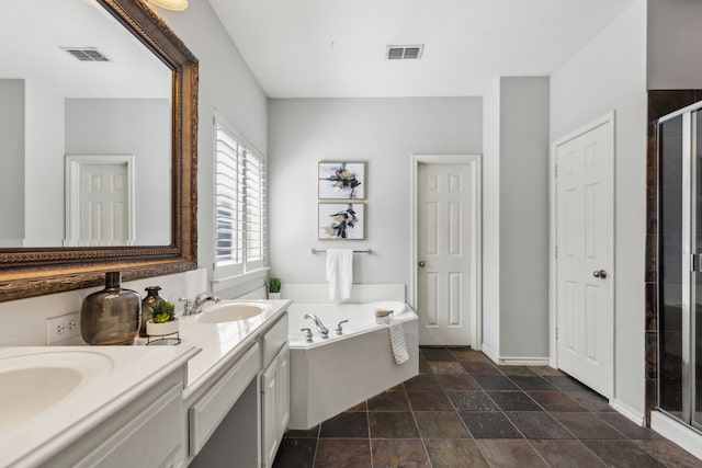 2398 April Sound Ln, Frisco, TX 75033 - bathroom with a shower stall, double vanity, a garden tub, baseboards, and stone finish flooring