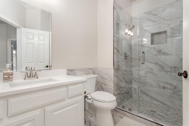 3700 Wagon Wheel Ct, Richardson, TX 75082 - full bathroom featuring vanity, a marble finish shower, tile walls, marble finish flooring, and wainscoting