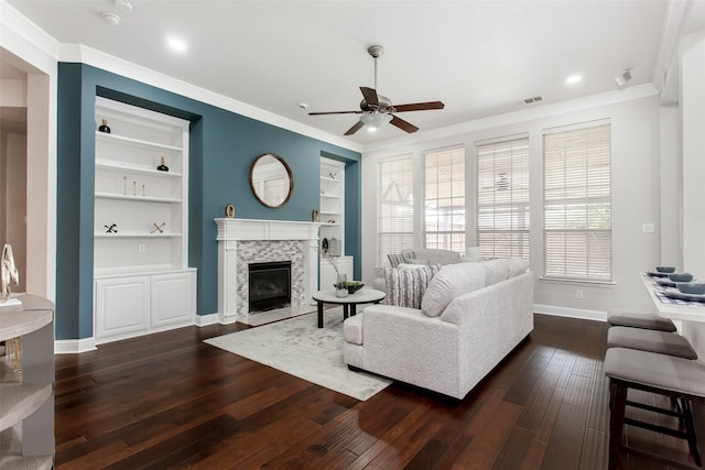 3700 Wagon Wheel Ct, Richardson, TX 75082 - living room featuring built in features, ceiling fan, dark wood-style floors, crown molding, and a fireplace with flush hearth