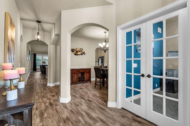 4323 Cherry Ln, Melissa, TX 75454 - foyer featuring arched walkways, french doors, wood finished floors, baseboards, and a chandelier