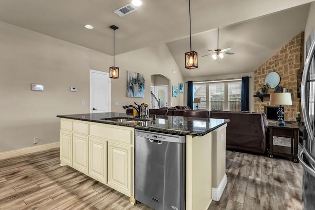 4323 Cherry Ln, Melissa, TX 75454 - kitchen with stainless steel appliances, a sink, cream cabinetry, lofted ceiling, and open floor plan