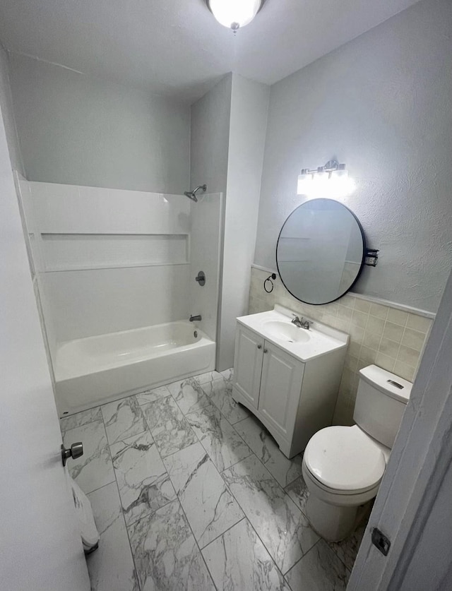 403 7th Ave, Mineral Wells, TX 76067 - full bath featuring toilet, vanity, tile walls, shower / washtub combination, and marble look tiles