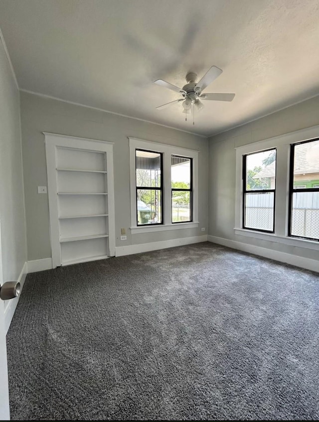 403 7th Ave, Mineral Wells, TX 76067 - carpeted spare room with healthy amount of natural light, baseboards, ceiling fan, and built in shelves