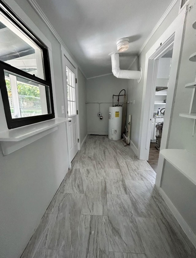 403 7th Ave, Mineral Wells, TX 76067 - laundry area featuring crown molding, water heater, marble look tile flooring, and baseboards