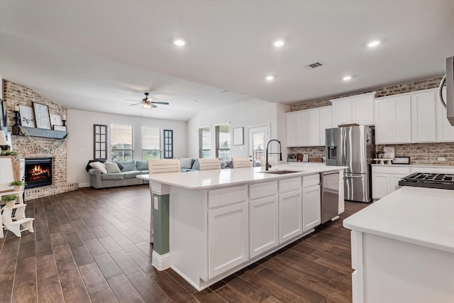 2709 Madera Canyon Rd, Aubrey, TX 76227 - kitchen featuring stainless steel appliances, a sink, ceiling fan, dark wood-style flooring, and light countertops