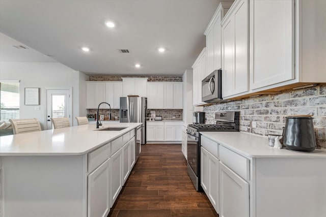 2709 Madera Canyon Rd, Aubrey, TX 76227 - kitchen featuring appliances with stainless steel finishes, a sink, dark wood finished floors, light countertops, and white cabinets