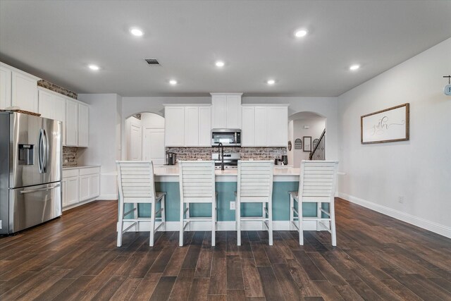 2709 Madera Canyon Rd, Aubrey, TX 76227 - kitchen with stainless steel appliances, arched walkways, decorative backsplash, dark wood-style flooring, and recessed lighting
