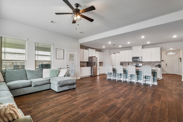 2709 Madera Canyon Rd, Aubrey, TX 76227 - living room with arched walkways, ceiling fan, dark wood-style flooring, and recessed lighting