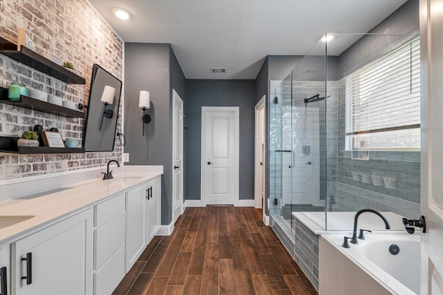 2709 Madera Canyon Rd, Aubrey, TX 76227 - bathroom featuring a stall shower, a garden tub, double vanity, wood finished floors, and baseboards