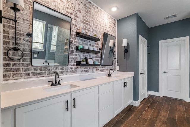 2709 Madera Canyon Rd, Aubrey, TX 76227 - bathroom with double vanity, wood finished floors, baseboards, and tiled shower