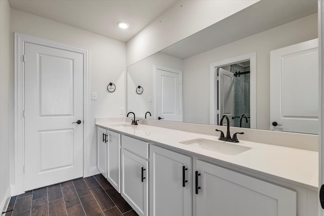 2709 Madera Canyon Rd, Aubrey, TX 76227 - bathroom with double vanity, baseboards, wood finished floors, a shower, and recessed lighting