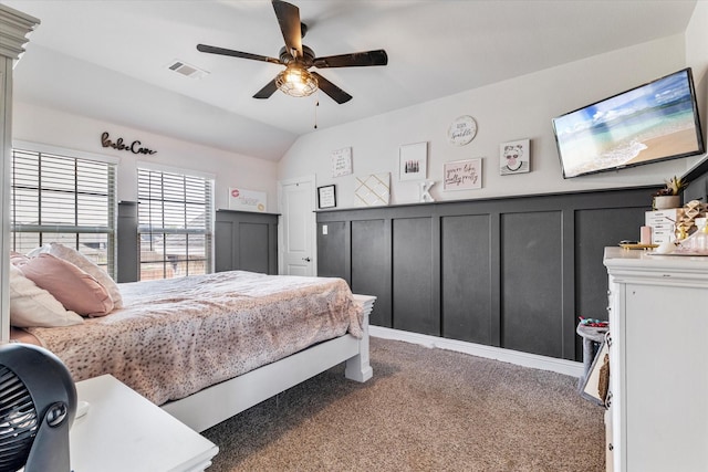 2709 Madera Canyon Rd, Aubrey, TX 76227 - carpeted bedroom with vaulted ceiling, a decorative wall, wainscoting, and ceiling fan