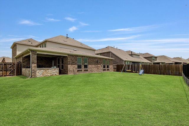 2709 Madera Canyon Rd, Aubrey, TX 76227 - back of property with a playground, brick siding, and roof with shingles