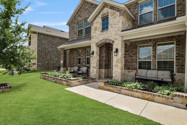 2709 Madera Canyon Rd, Aubrey, TX 76227 - view of front of home with a front lawn, brick siding, and a patio area