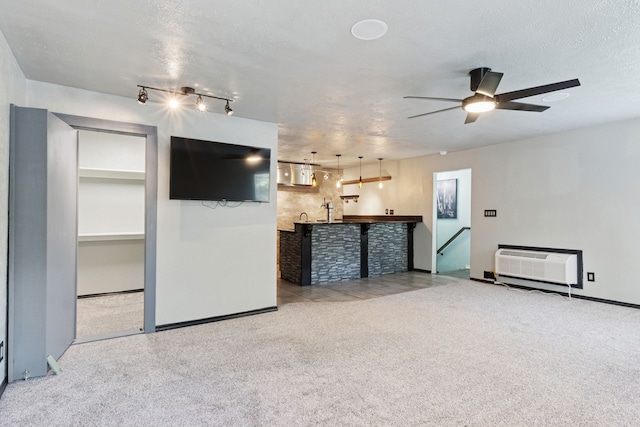 3100 Jomar Dr, Plano, TX 75075 - unfurnished living room featuring ceiling fan, a wall mounted AC, carpet, and baseboards