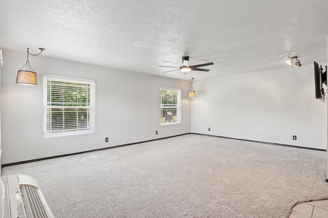 3100 Jomar Dr, Plano, TX 75075 - spare room featuring ceiling fan, carpet floors, baseboards, and a textured ceiling