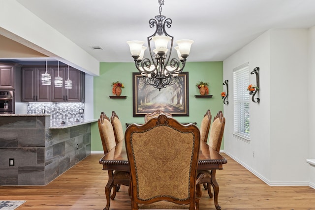 3100 Jomar Dr, Plano, TX 75075 - dining space with a chandelier, light wood-type flooring, and baseboards