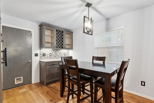 3100 Jomar Dr, Plano, TX 75075 - dining area with light wood finished floors, a chandelier, and baseboards