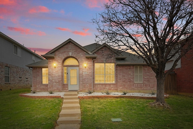 1689 Big Bend Dr, Lewisville, TX 75077 - view of front of property with a shingled roof, a front yard, and brick siding