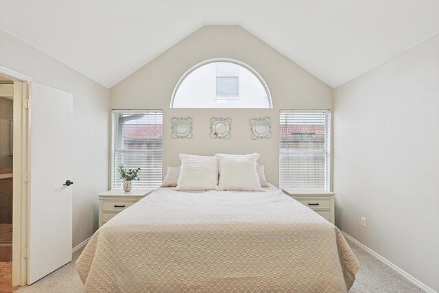 1689 Big Bend Dr, Lewisville, TX 75077 - bedroom featuring light carpet, multiple windows, vaulted ceiling, and baseboards