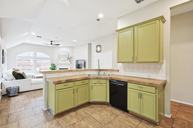 1689 Big Bend Dr, Lewisville, TX 75077 - kitchen featuring black dishwasher, green cabinetry, open floor plan, a fireplace, and decorative backsplash