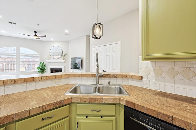 1689 Big Bend Dr, Lewisville, TX 75077 - kitchen with green cabinets, a sink, dishwasher, tile countertops, and ceiling fan