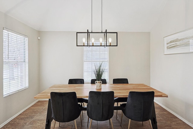 1689 Big Bend Dr, Lewisville, TX 75077 - dining area featuring healthy amount of natural light, baseboards, a chandelier, and vaulted ceiling